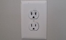 Electrical outlet with heat damage and discoloration that may produce a burning smell